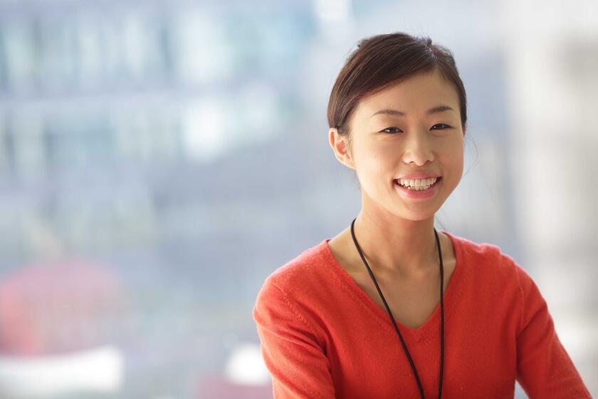 Associate standing in front of a window